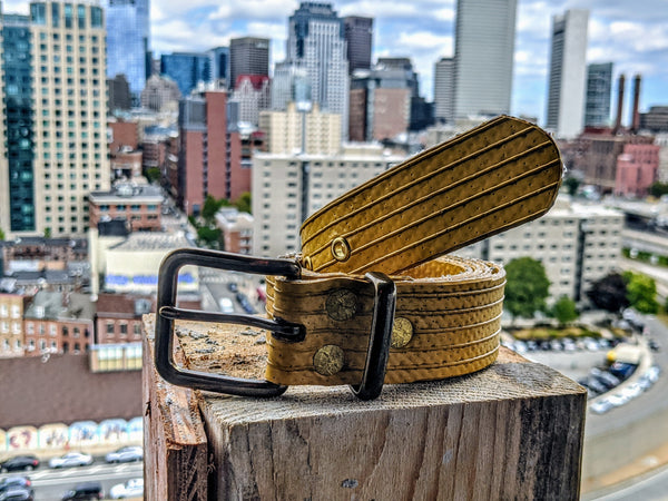 Repurposed 1-1/4 rubber firehose belt with antique brass buckle and eyelets