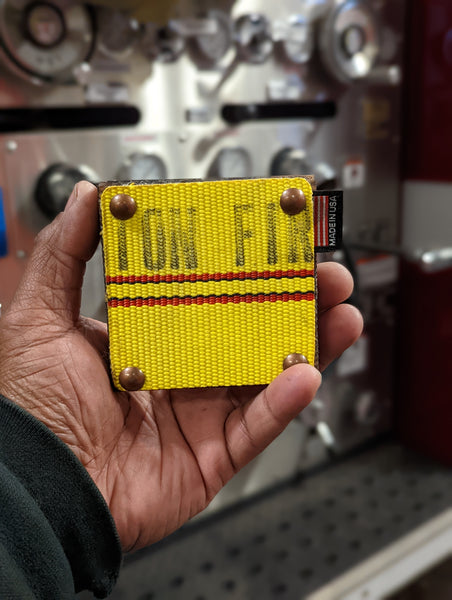 Repurposed fire hose coaster with decorative furniture tacks and personalized message. Makes a great gift for that special man in your life.